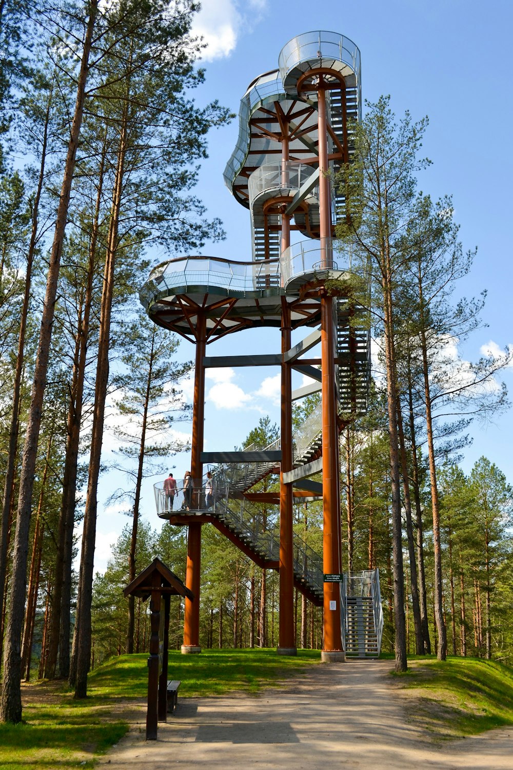 brown metal tower near trees during daytime