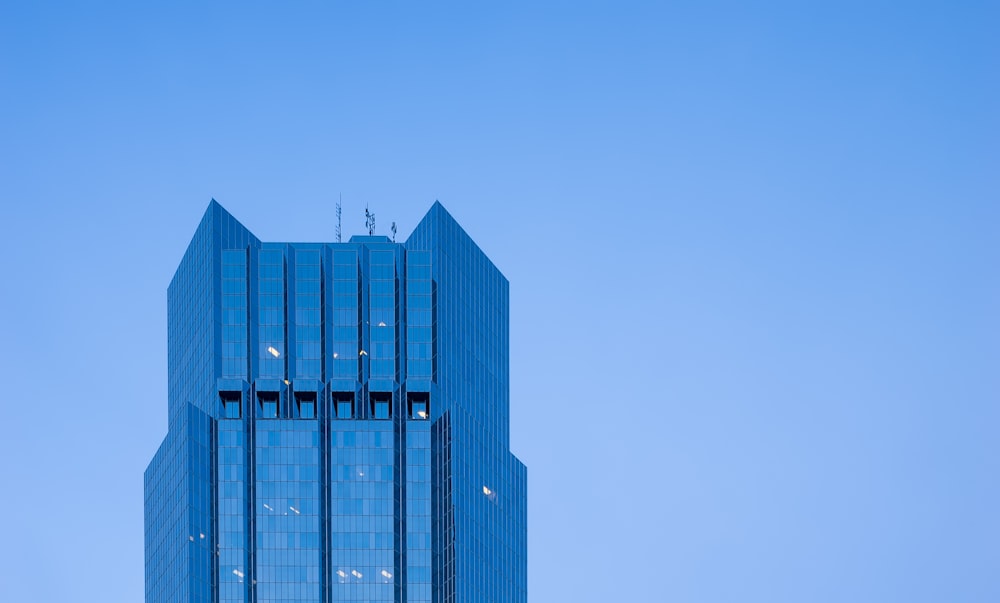 blue glass walled high rise building