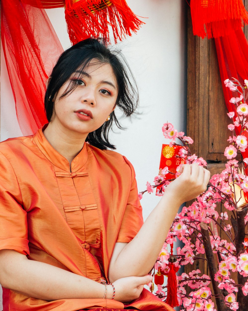 woman in orange button up shirt smiling