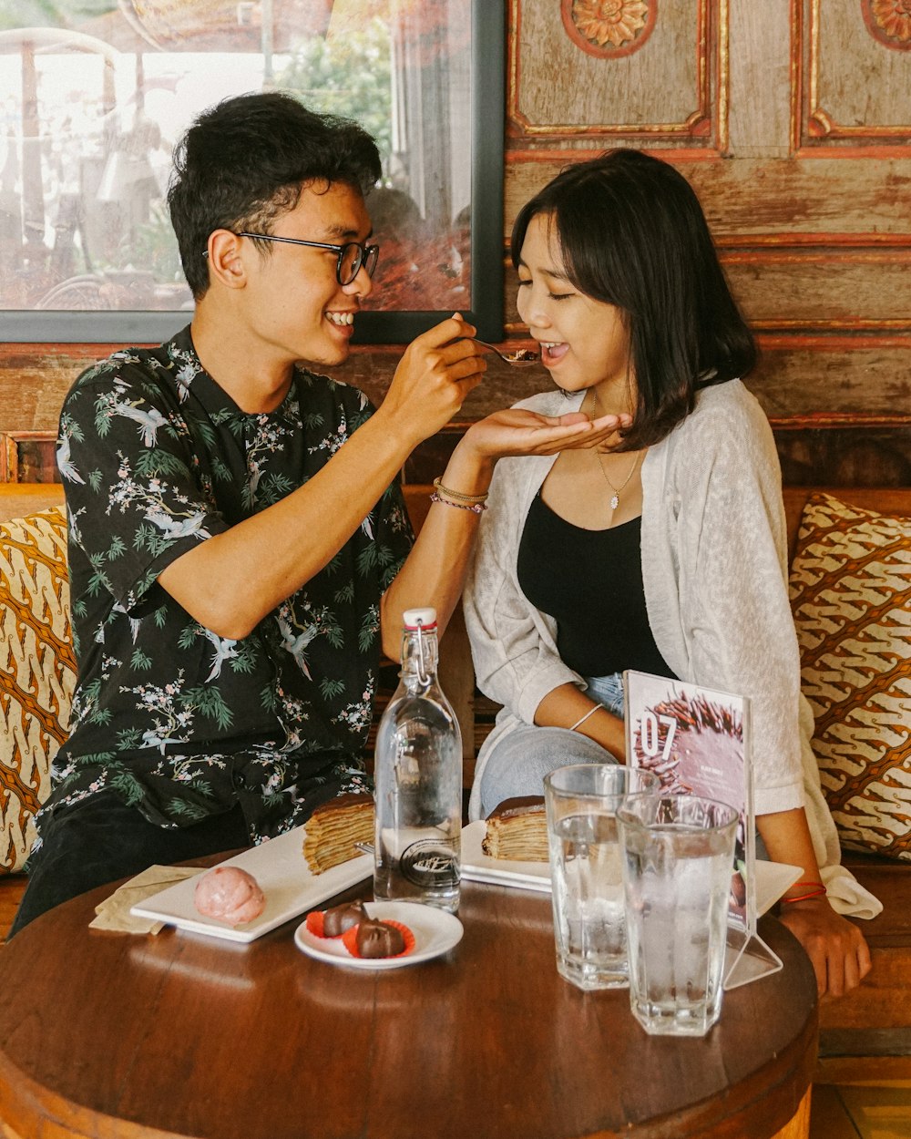 man and woman sitting beside table