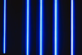 Close-up of vibrant blue LED lights glowing against a dark background with neon accents.