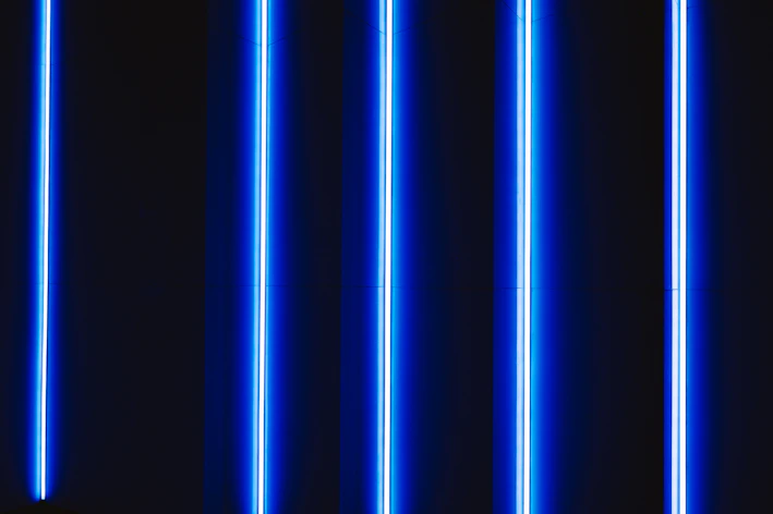 Close-up of vibrant blue LED lights glowing against a dark background with neon accents.