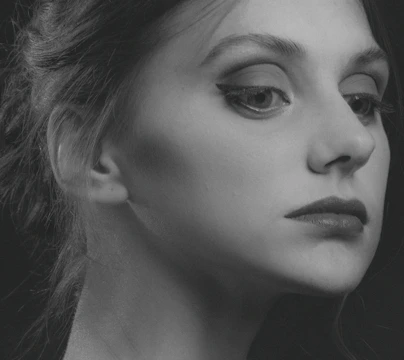 Digital portrait featuring a thoughtful gaze with soft shadows and clean background.