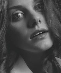 Close-up portrait of a person with expressive eyes and natural lighting.