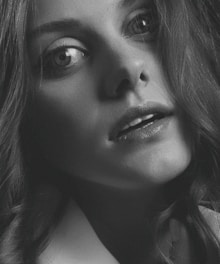 A close-up portrait of a person with expressive eyes and natural lighting.