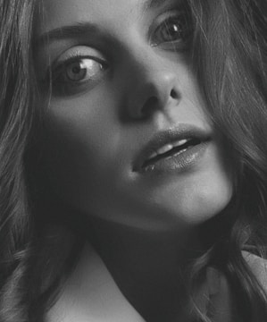 A close-up portrait of a person with expressive eyes and natural lighting.