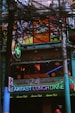 a restaurant with neon signs on the front of it