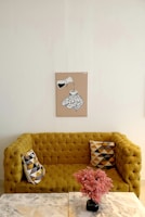 A vibrant mustard yellow sofa with tufted backrest, perfect for a lively space.