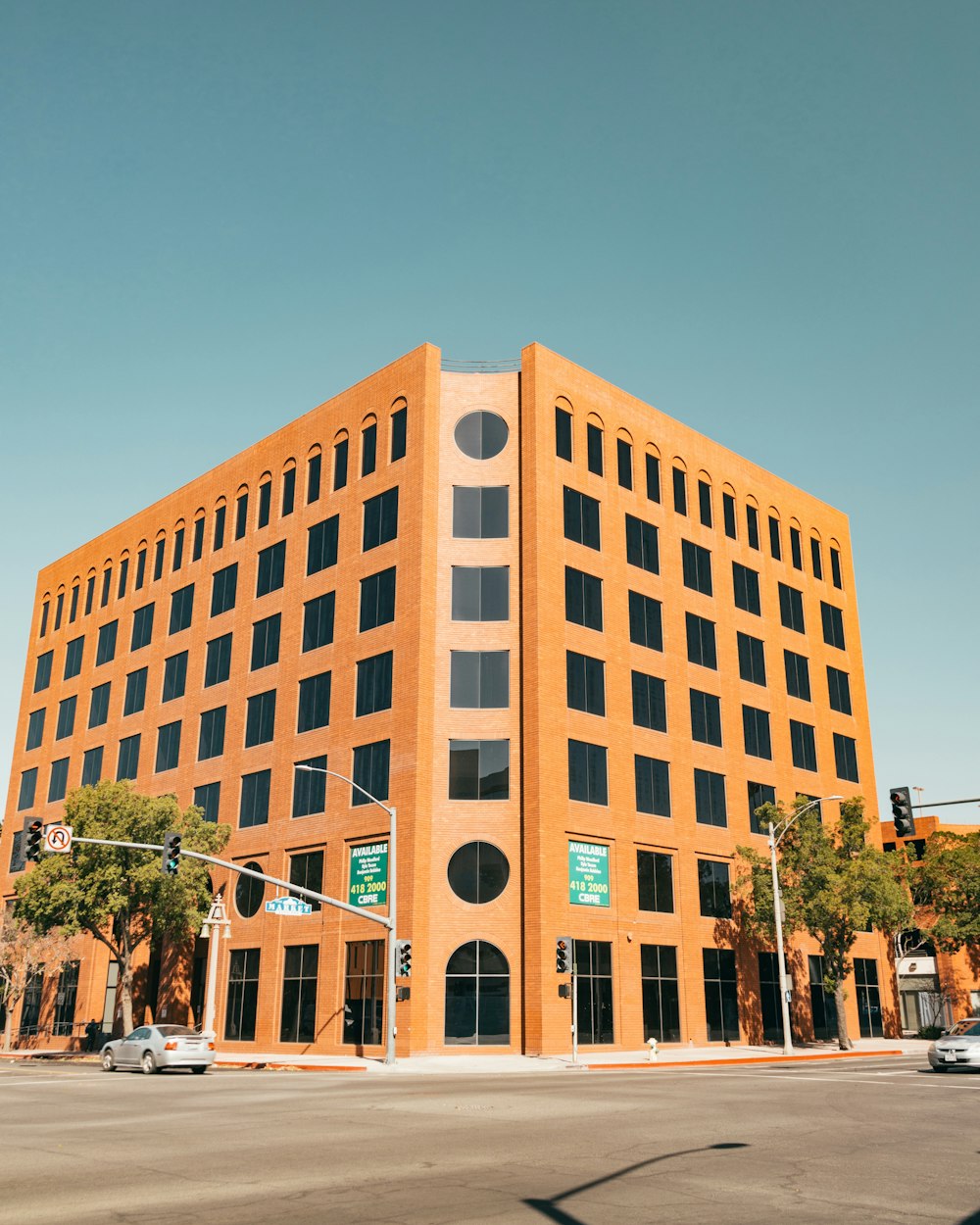 brown concrete building near green trees during daytime