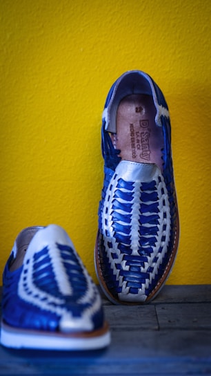 Close-up of a handmade leather sandal with natural stitching details.