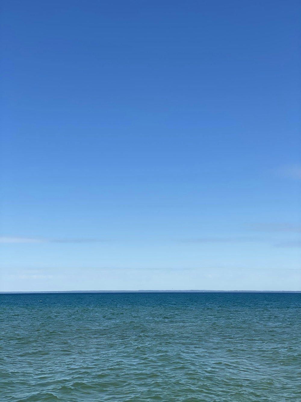 blue ocean under blue sky during daytime