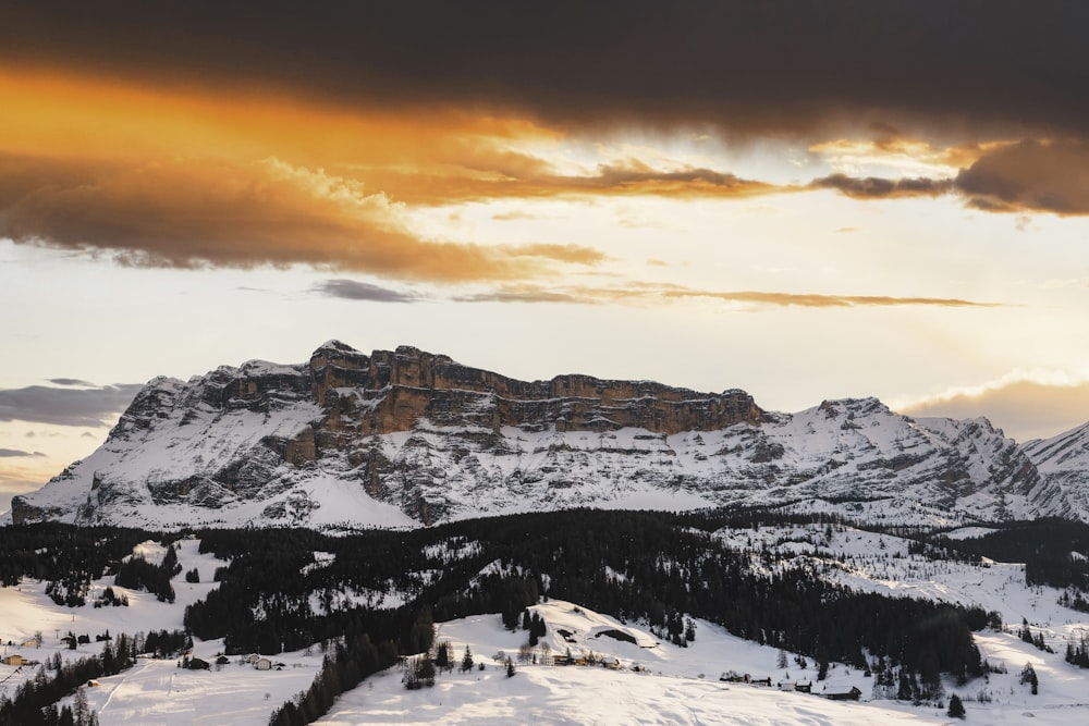 snow covered mountain during sunset