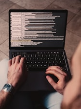 person using black laptop computer