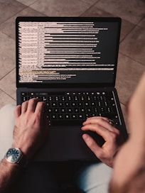 person using black laptop computer