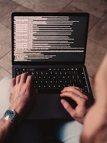 person using black laptop computer