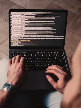 person using black laptop computer