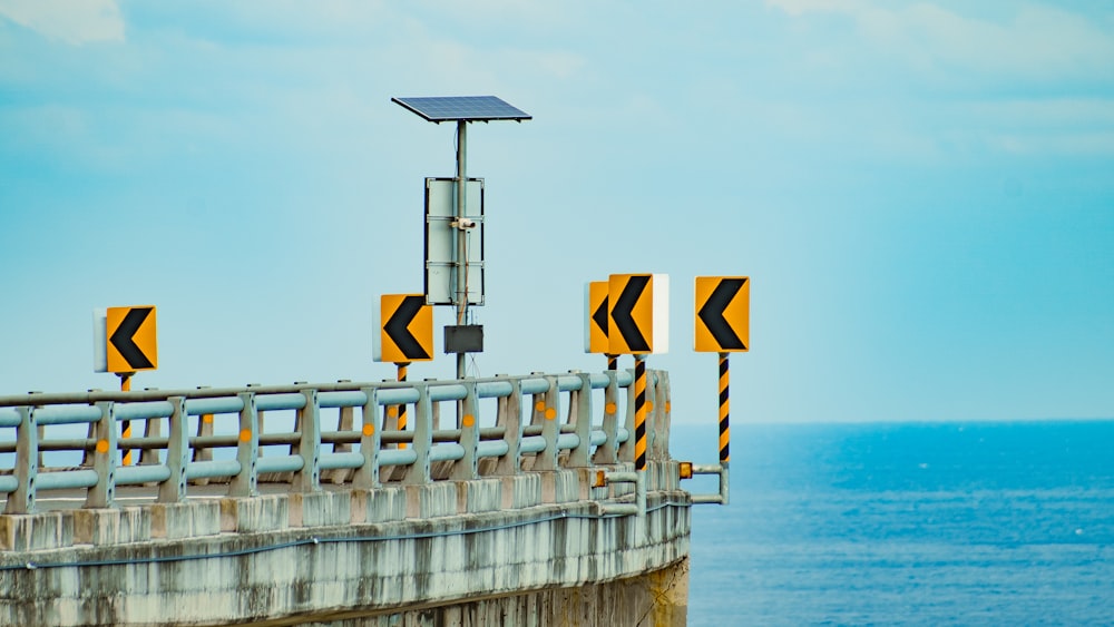 white and black wooden lifeguard tower near body of water during daytime