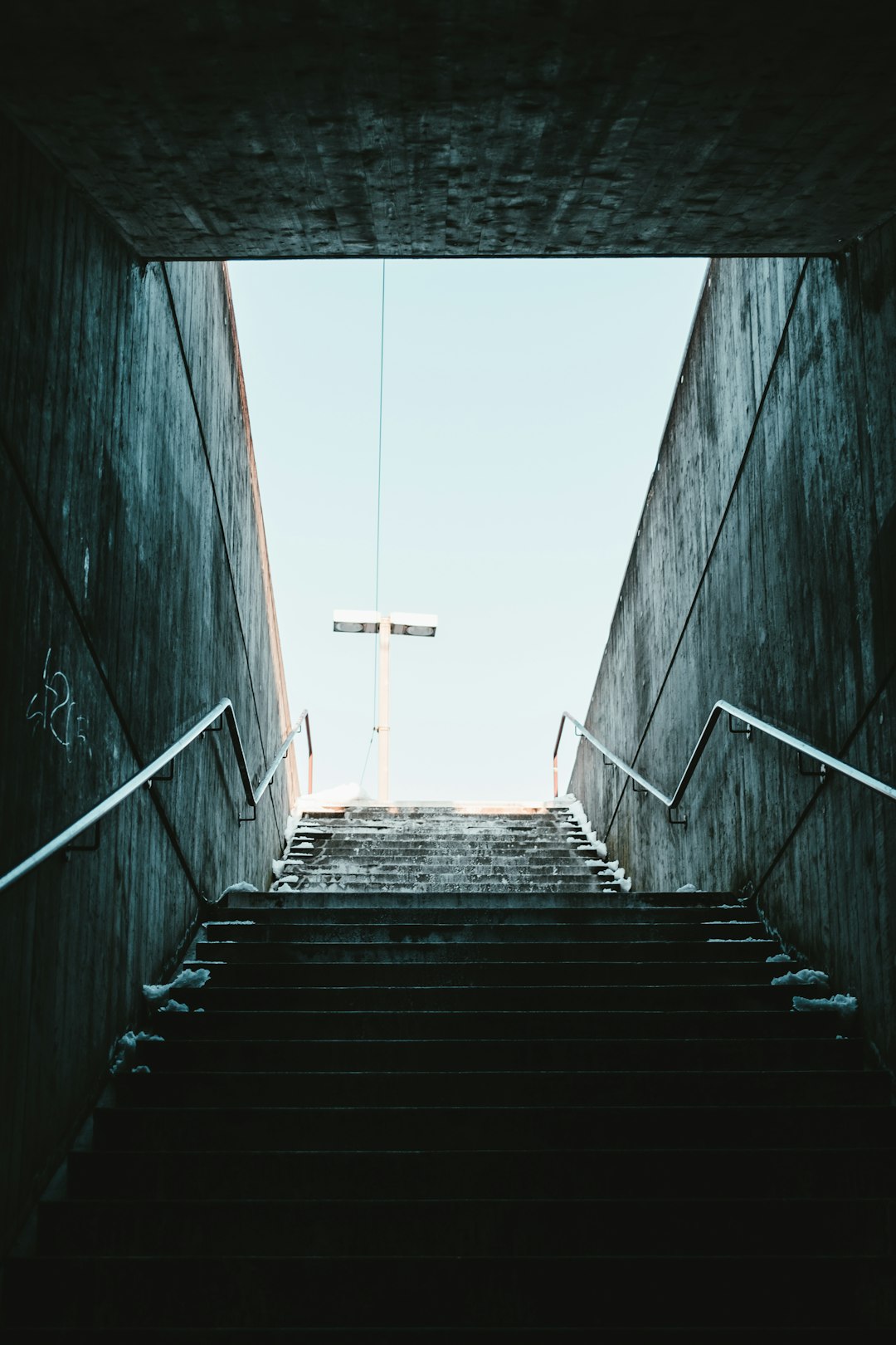 black and white staircase with stainless steel railings