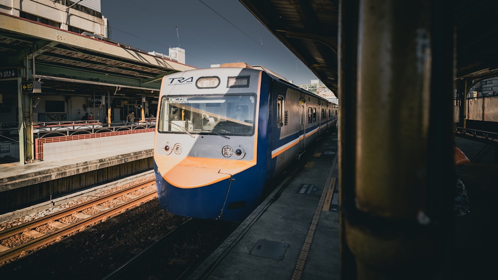 blue and white train on rail