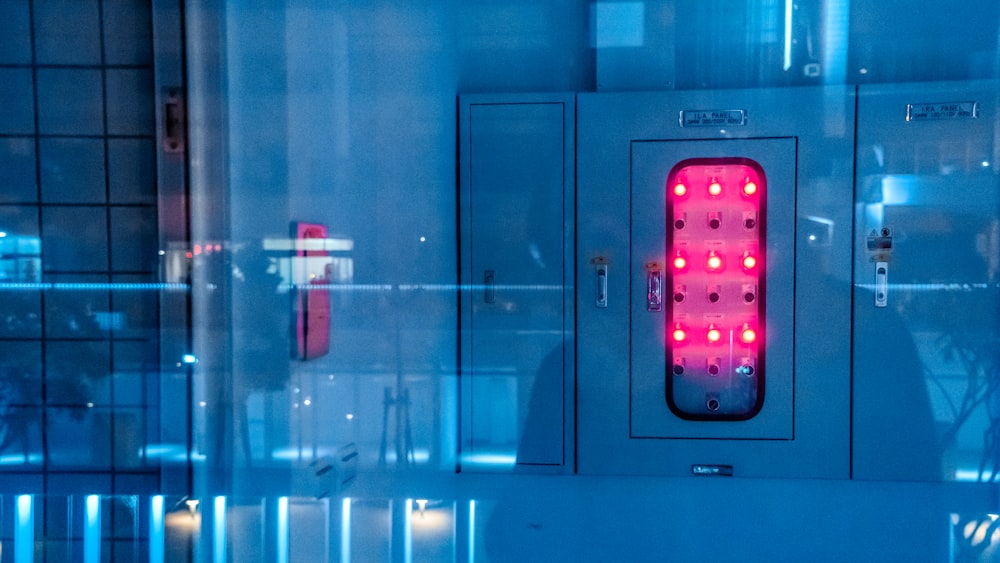 white and red switch on gray wall