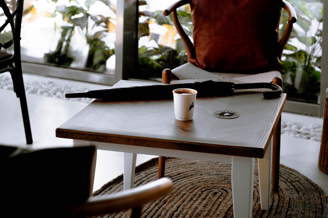 white ceramic mug on brown wooden table