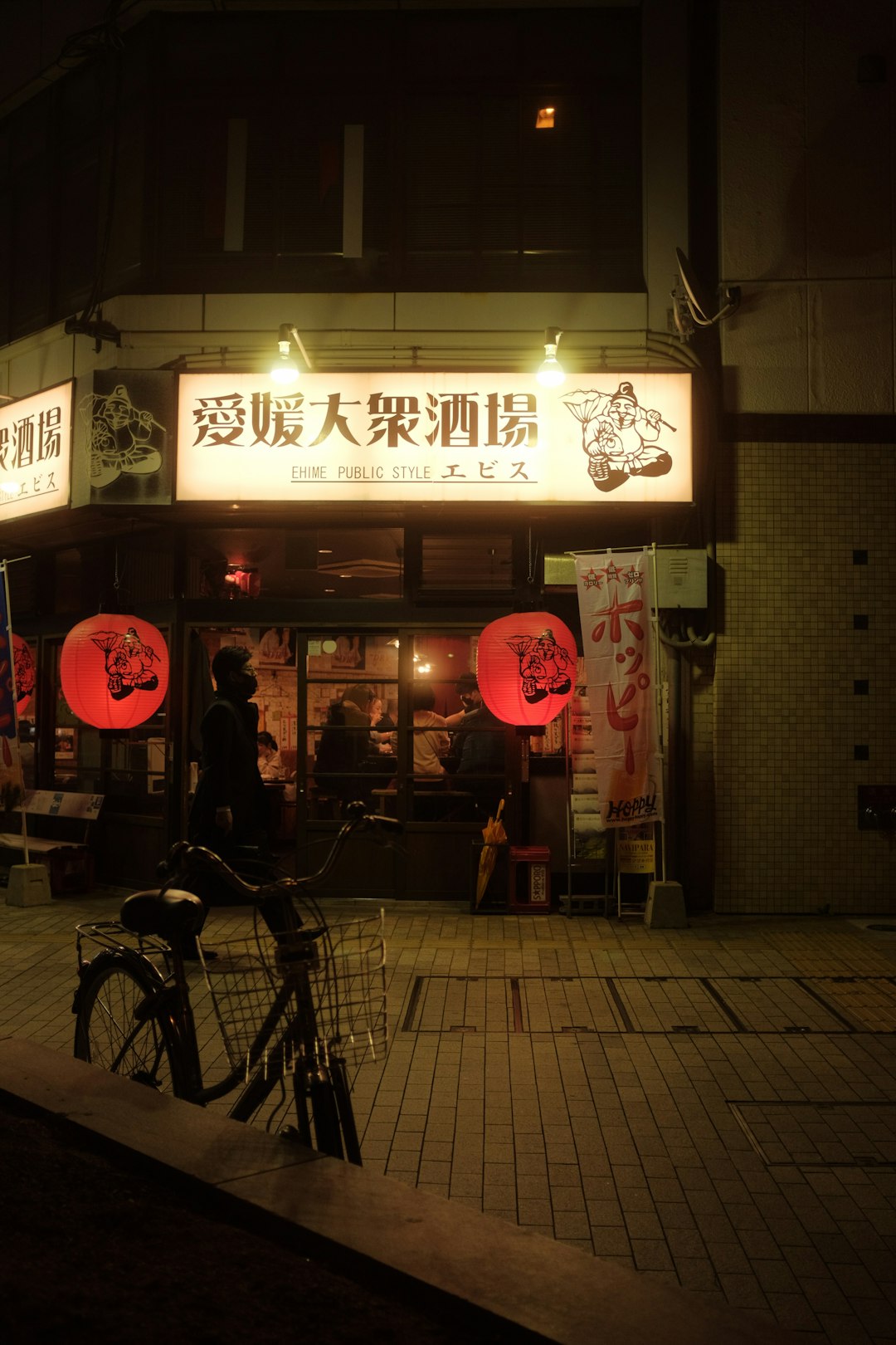 black bicycle parked beside store during night time