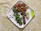 Close-up of crispy rice flour fritters with vibrant red and green sauces on a modern plate.