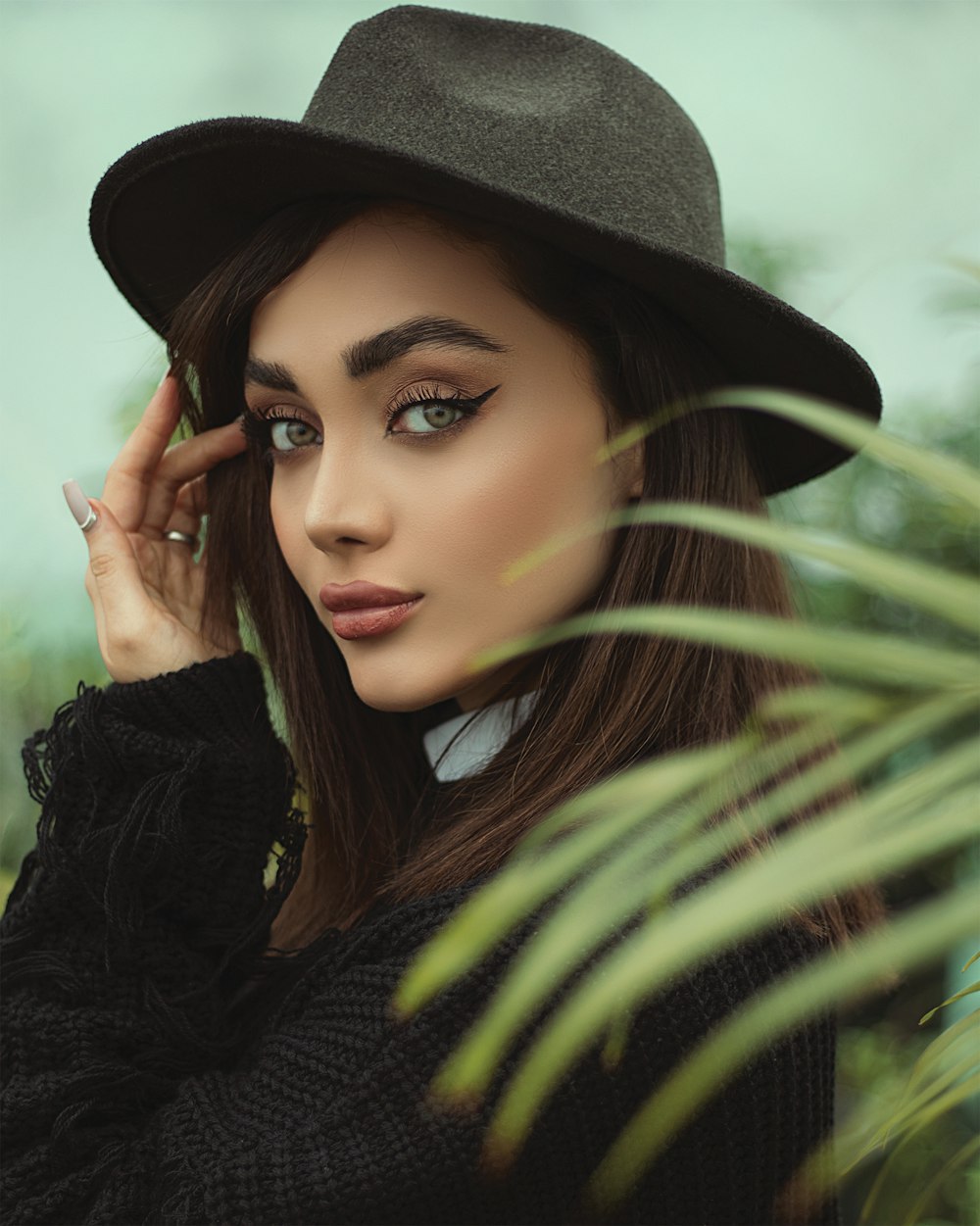 woman in black long sleeve shirt wearing black hat