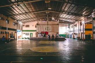Volunteers organizing sports equipment in the school gym