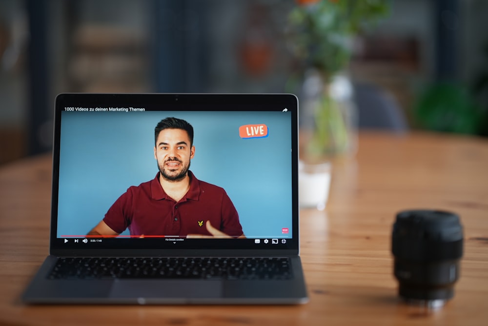 black laptop computer on brown wooden table