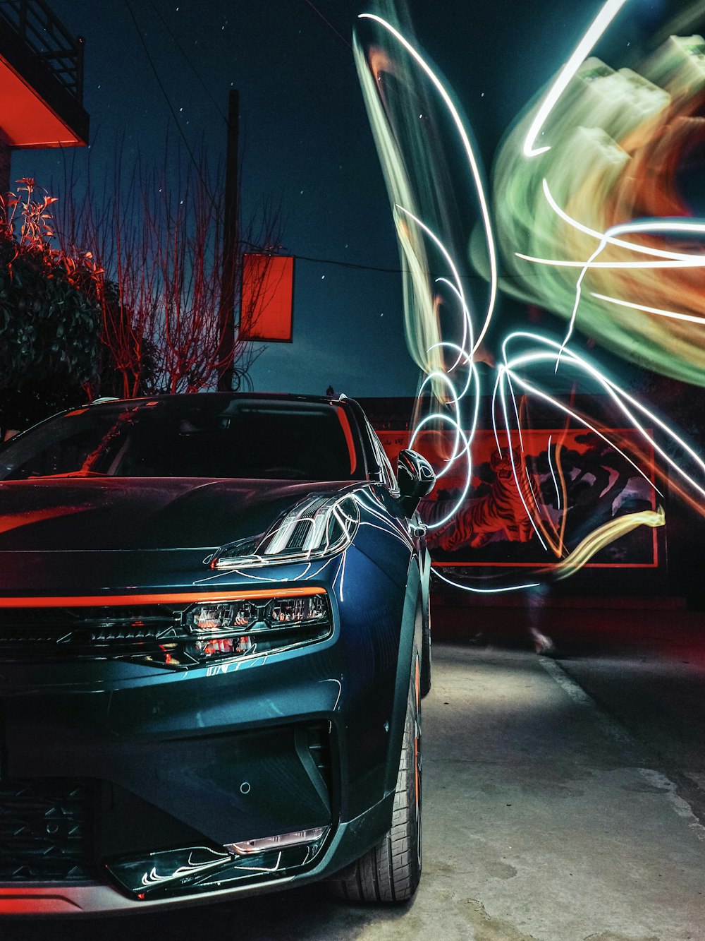 black car with lights on road during night time