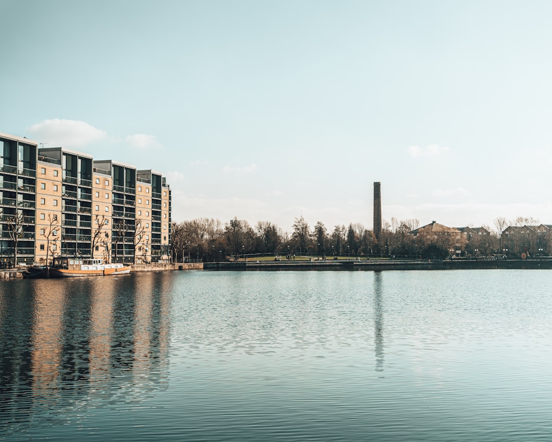 body of water near city buildings during daytime