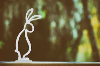 A sleek black background with a glowing rabbit silhouette.
