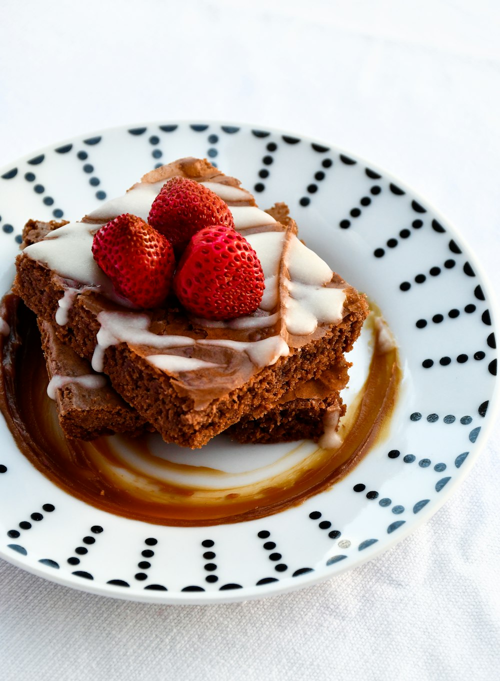 strawberry and chocolate cake on white ceramic plate