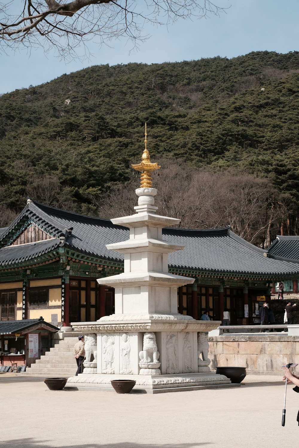 white and brown concrete temple near green mountain during daytime