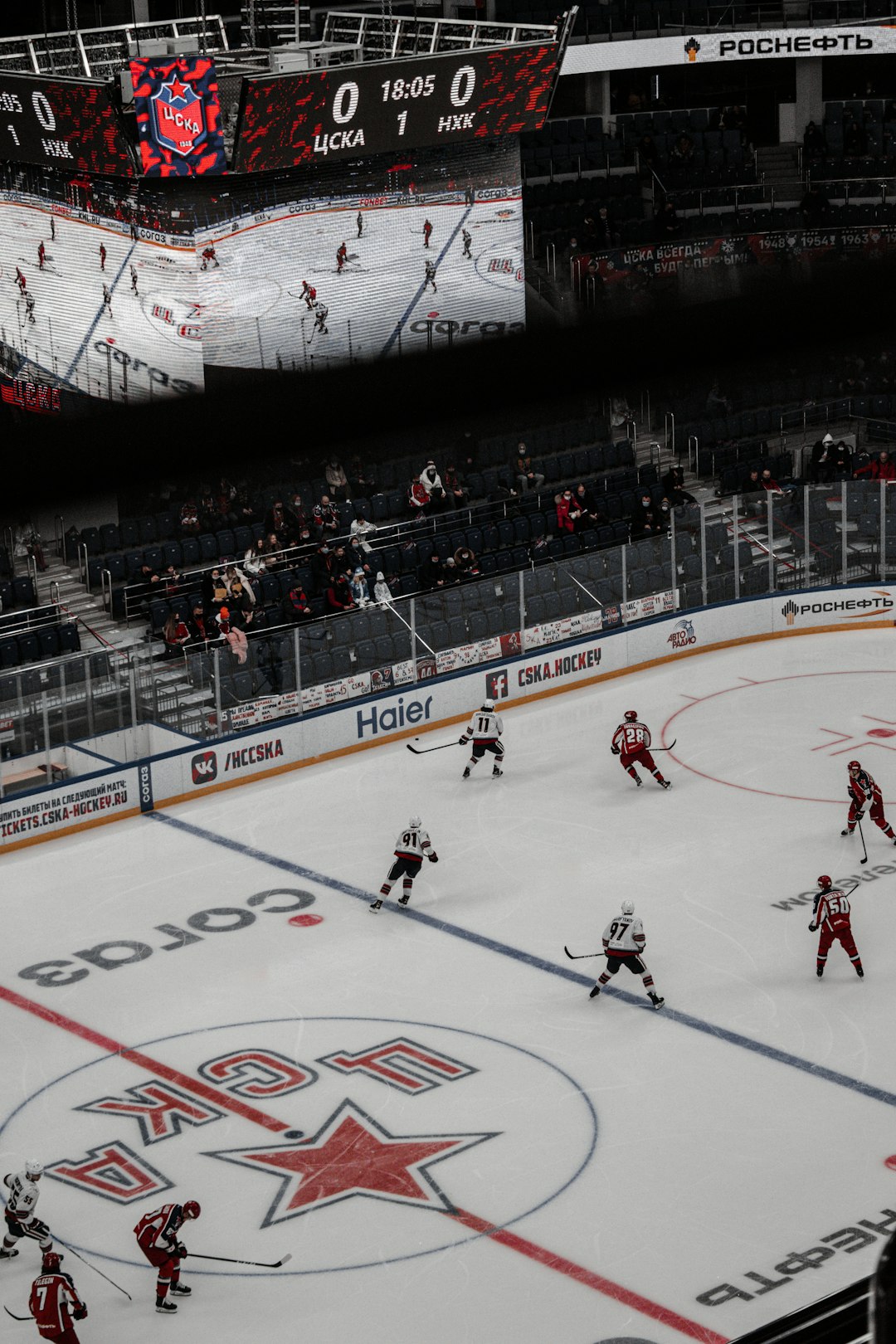 people playing ice hockey inside stadium