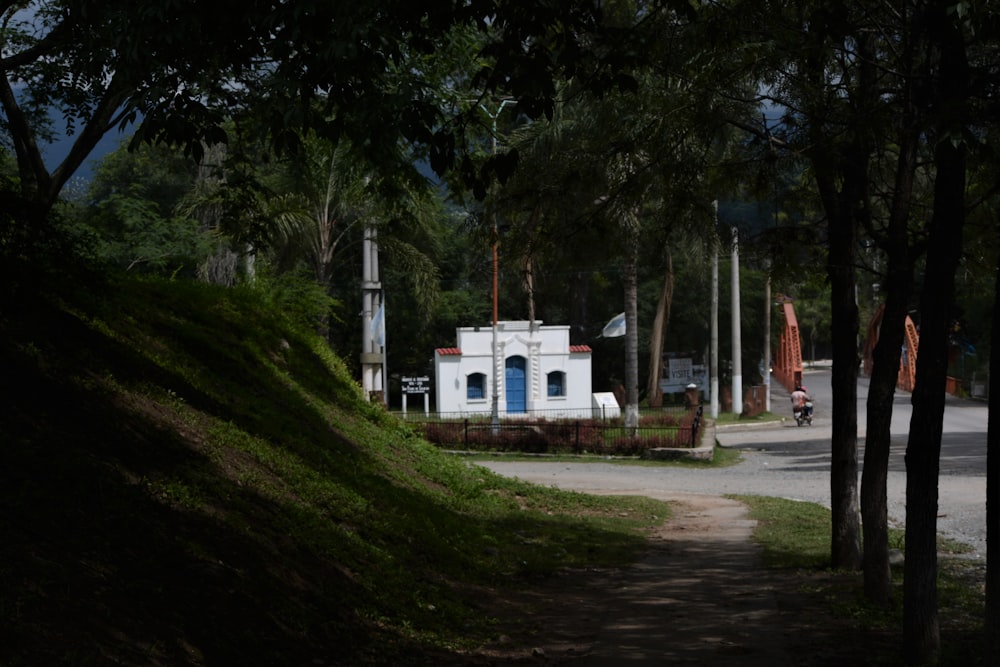 white concrete building near green trees during daytime