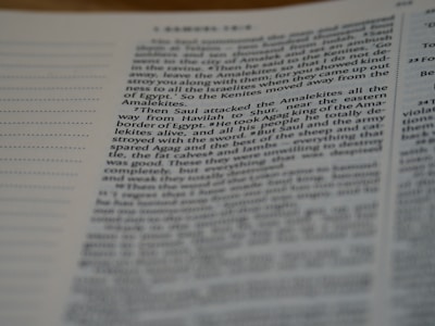 A close-up shot of a page from a book featuring text in a two-column layout. The text is clearly printed and slightly angled, with surrounding columns partially visible.