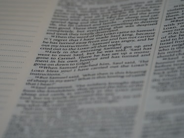 A close-up view of a printed page from a book featuring text in two columns. The focus is centered on a paragraph, with some text appearing slightly blurred due to depth of field. The text is printed in black on white paper, with some section headings in bold.