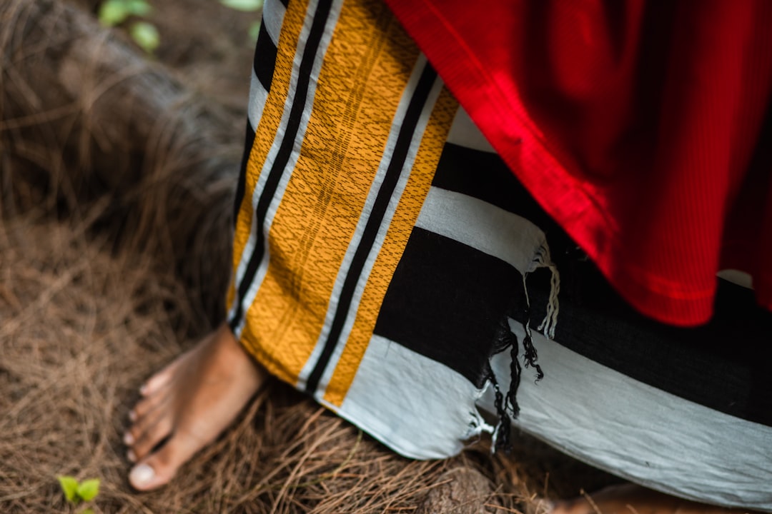 person in red white and black shorts