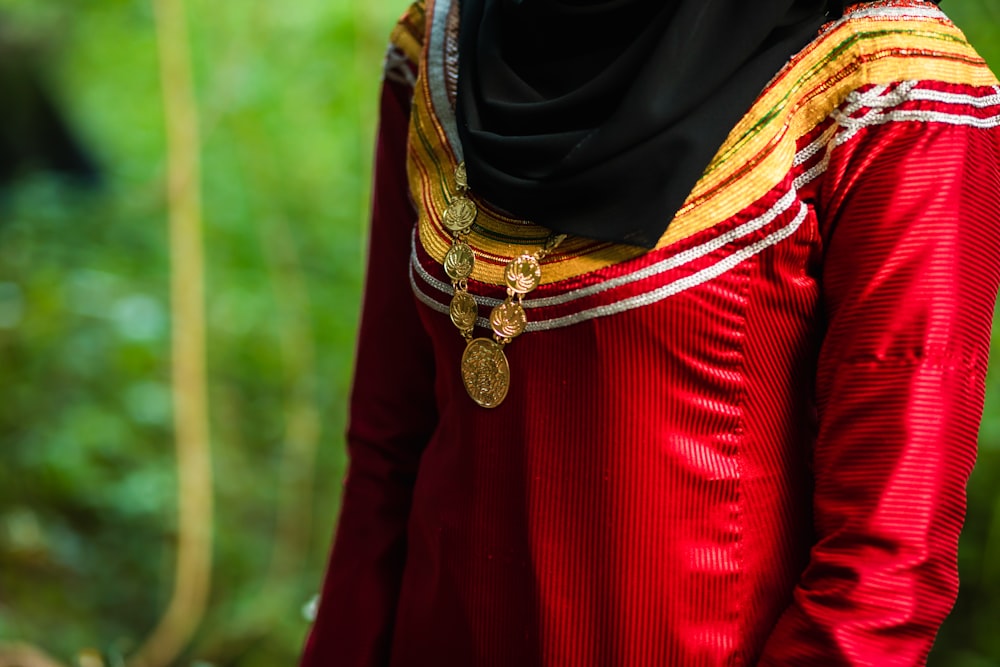 mulher no hijab preto e camisa vermelha de manga comprida