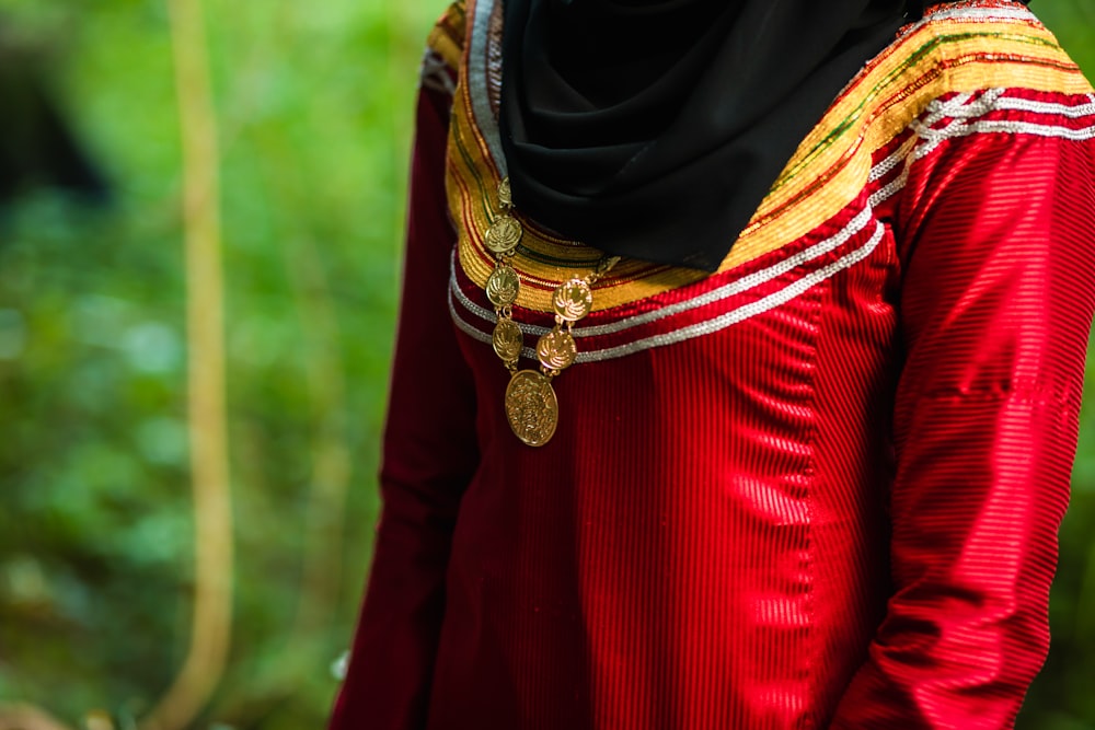 woman in black hijab and red long sleeve shirt