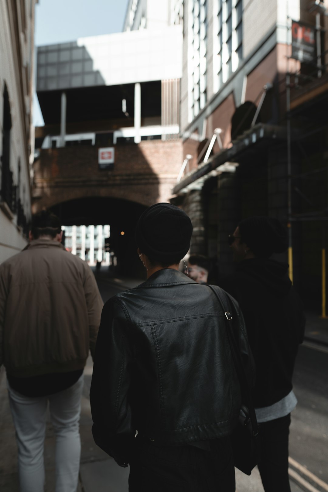 man in black jacket standing in front of man in black jacket