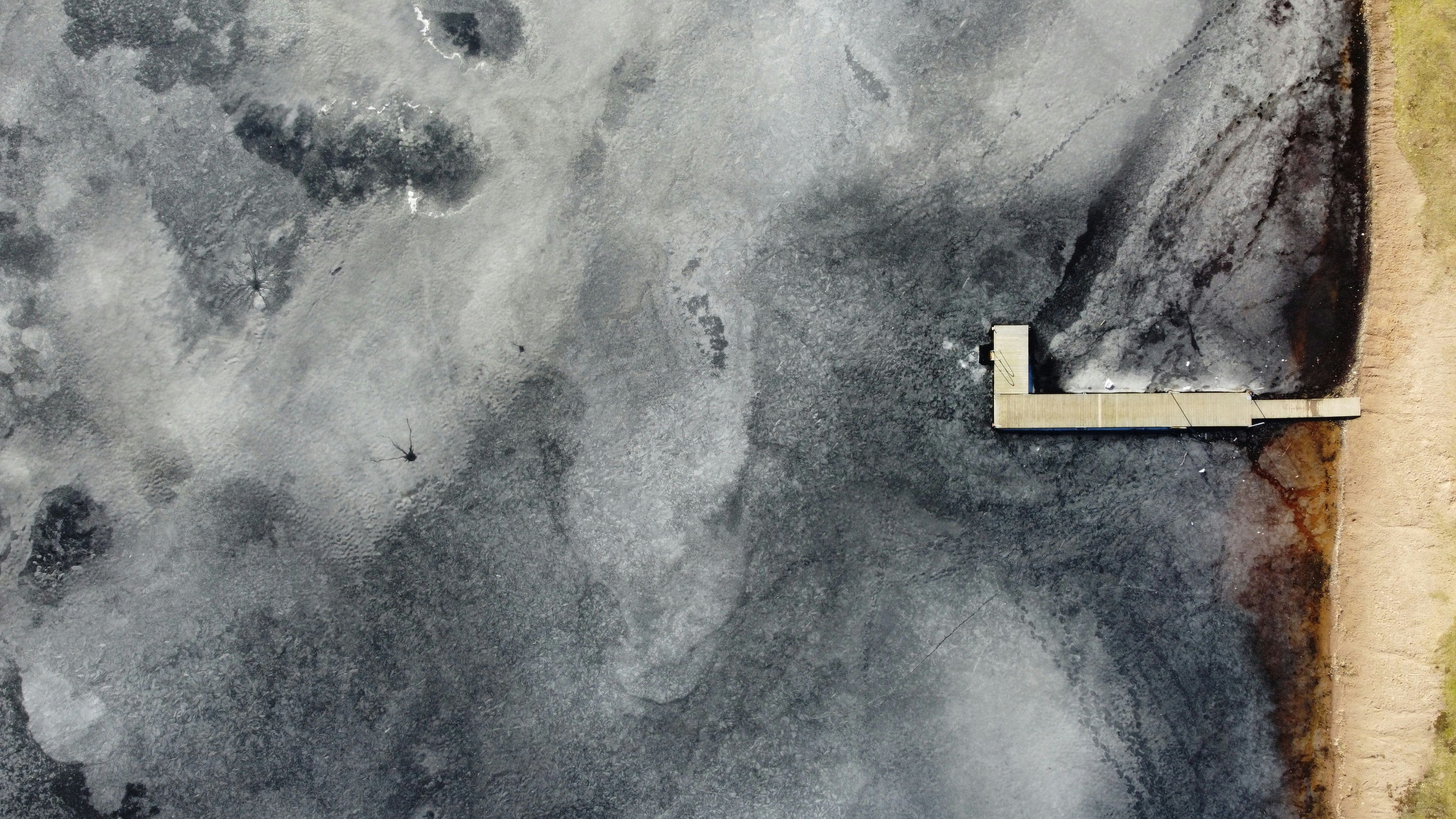 aerial view of white and black house on gray sand