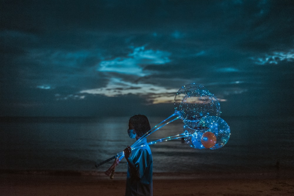 boy in blue shirt holding a balloon