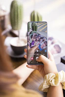 A candid photo of a woman holding a phone, representing someone chatting for gift cards.