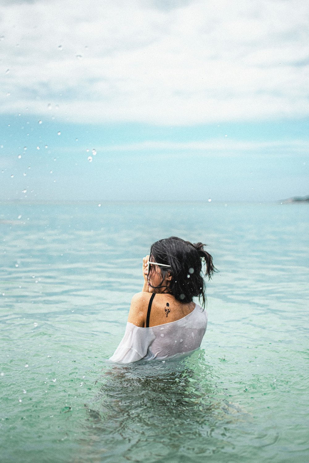 woman in white dress on water during daytime