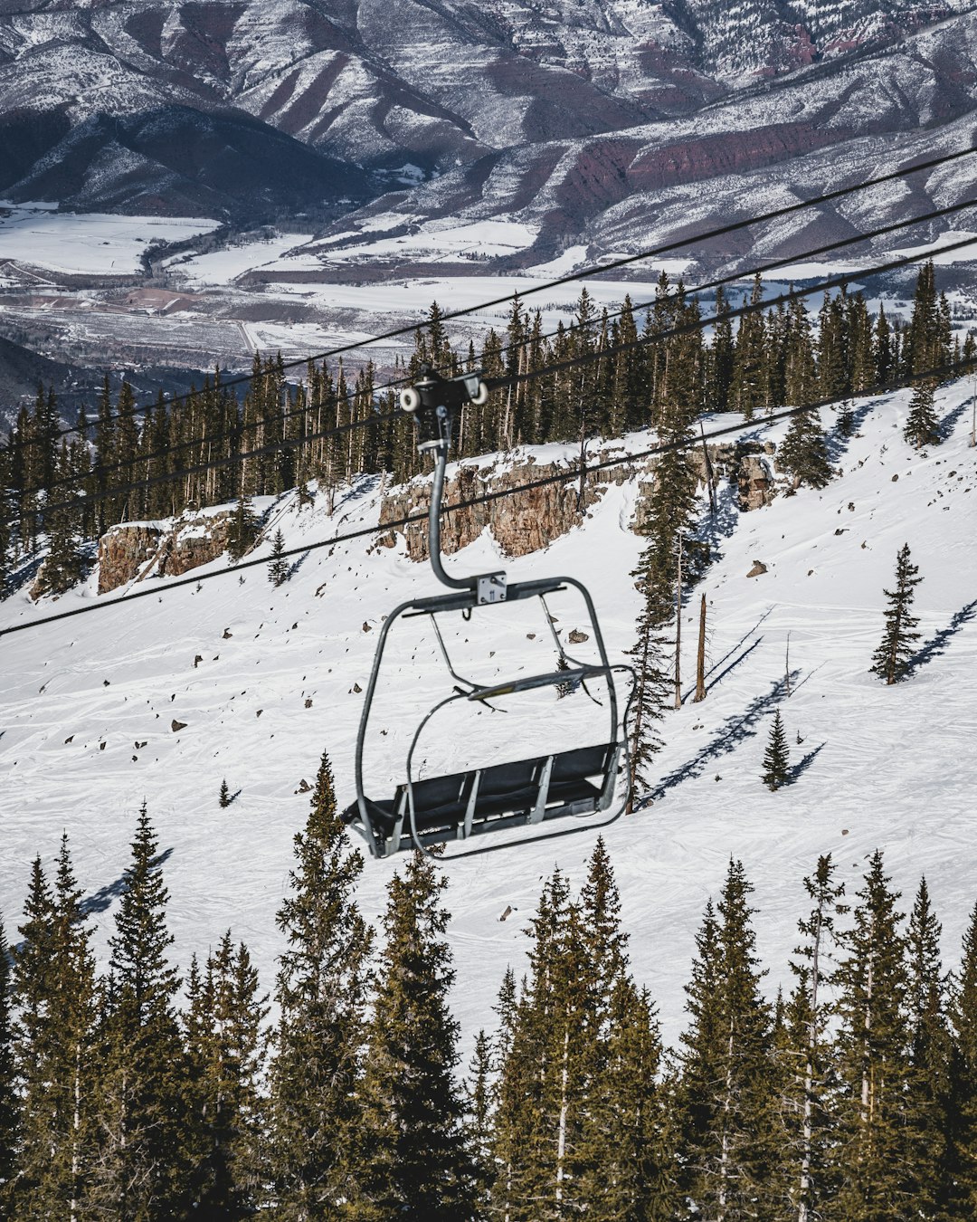 white and black cable car over snow covered mountain