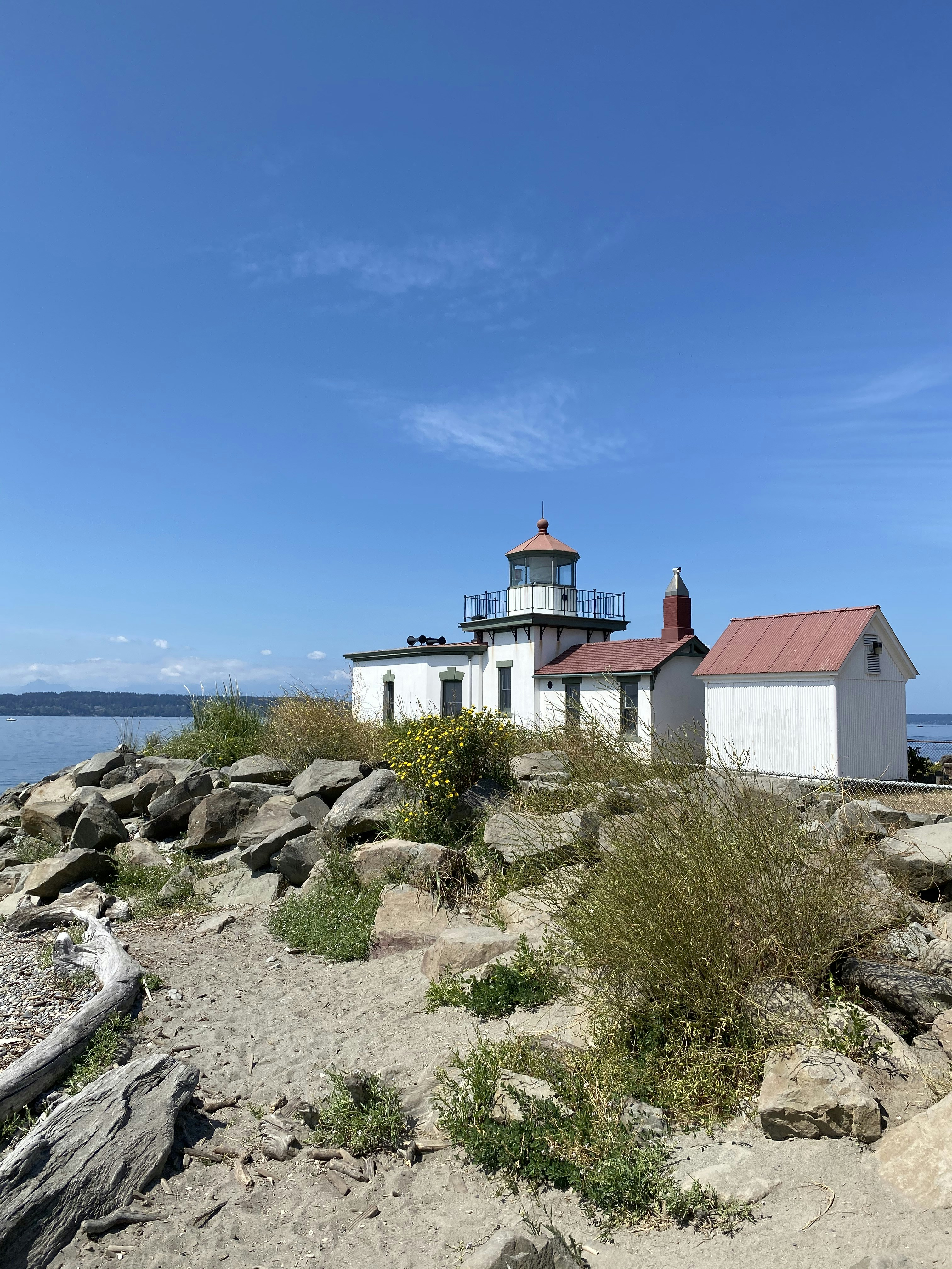 white and red house near body of water during daytime