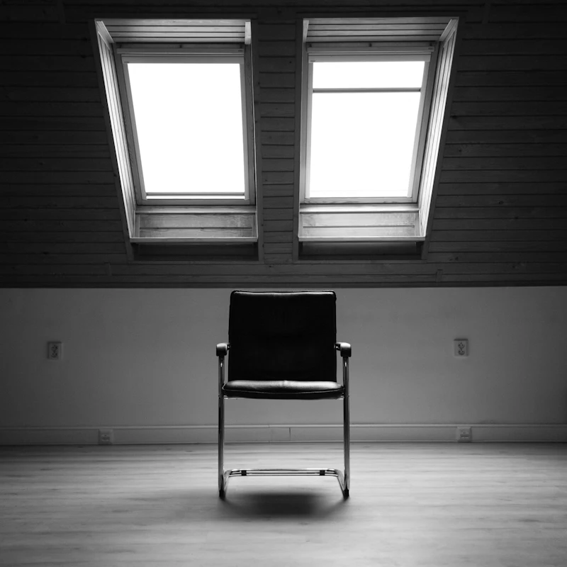Empty chair by a window in soft light